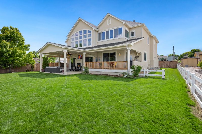 Beautiful two-story suburban house with a large green lawn and porch
